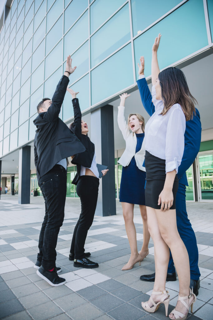 business team raising hands